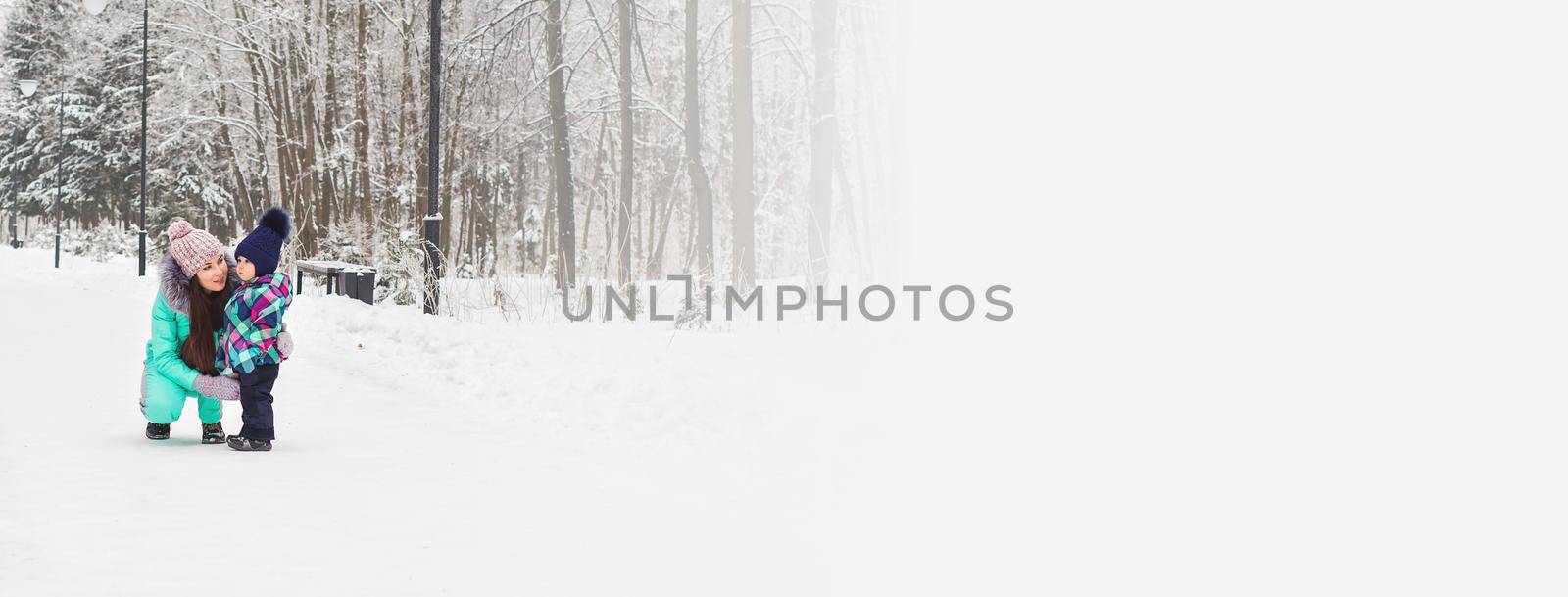 Banner little girl and her mom having fun on a winter day copy space by Satura86