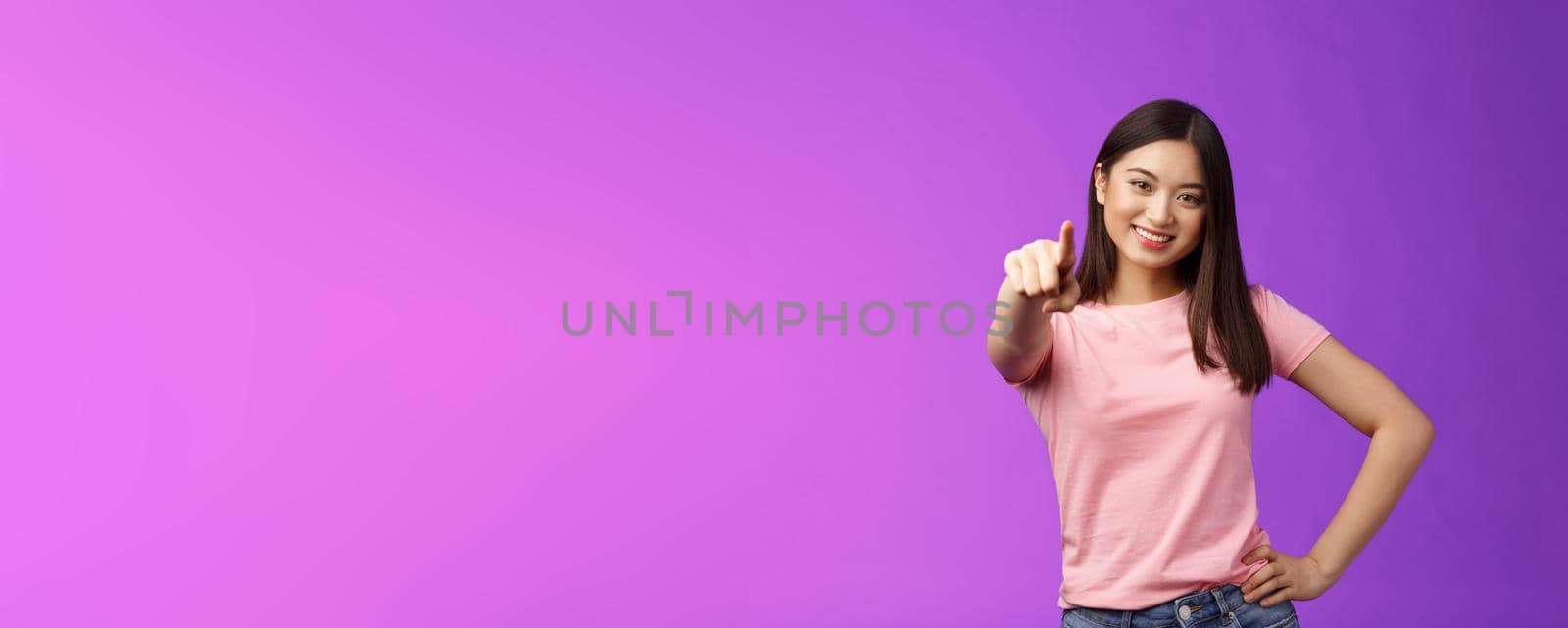 We need you our team. Friendly good-looking outgoing asian woman brunette pointing camera, indicate index finger, smiling motivated, picking person, making decision, stand purple background by Benzoix