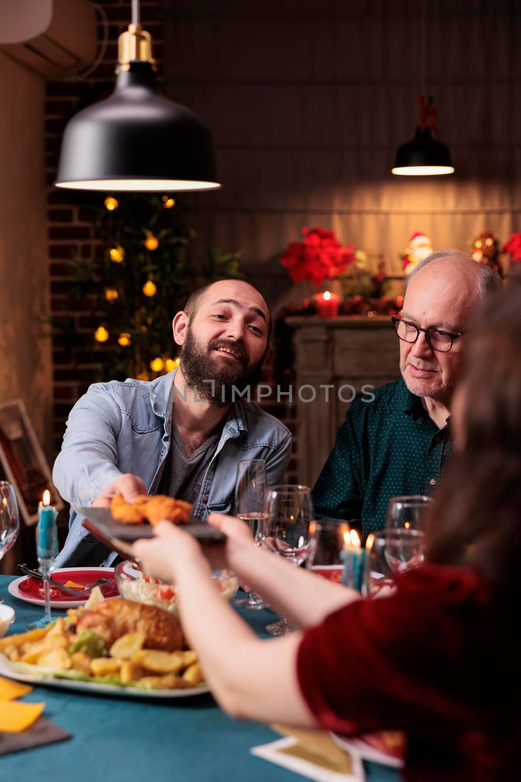 Family having christmas festive dinner, eating traditional food by DCStudio