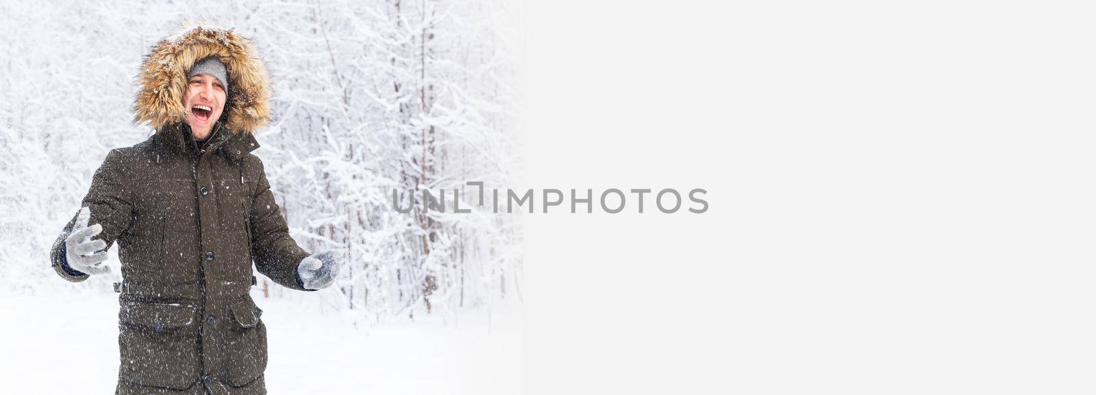 Banner happy funny male portrait looking snowflakes falling down by Satura86