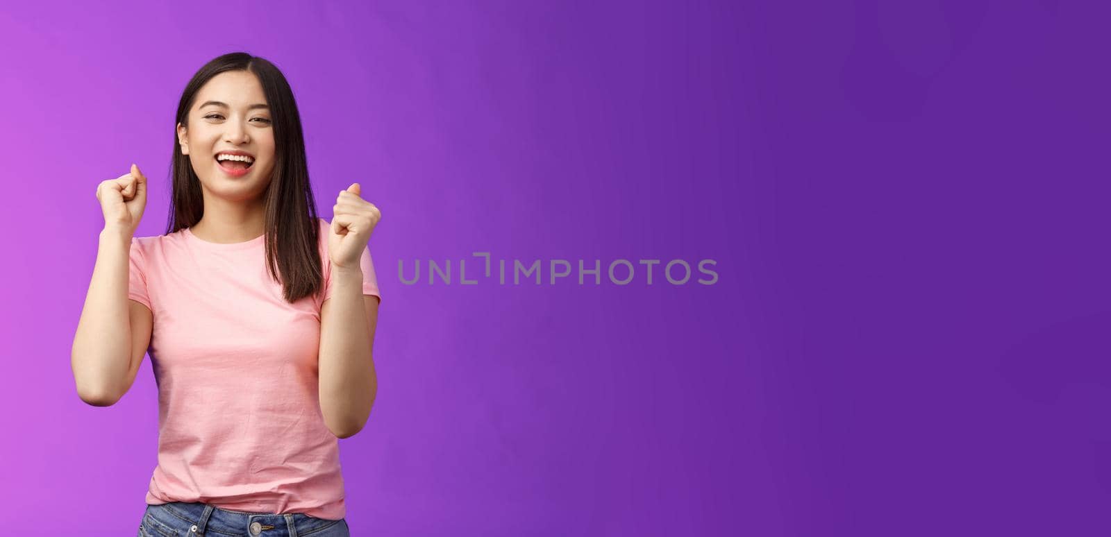 Hooray lucky win. Cheerful attractive astian girl make fist pump, dancing celebrate victory, stand purple background joyful, achieve excellent news grinning happily, move rhythm music.