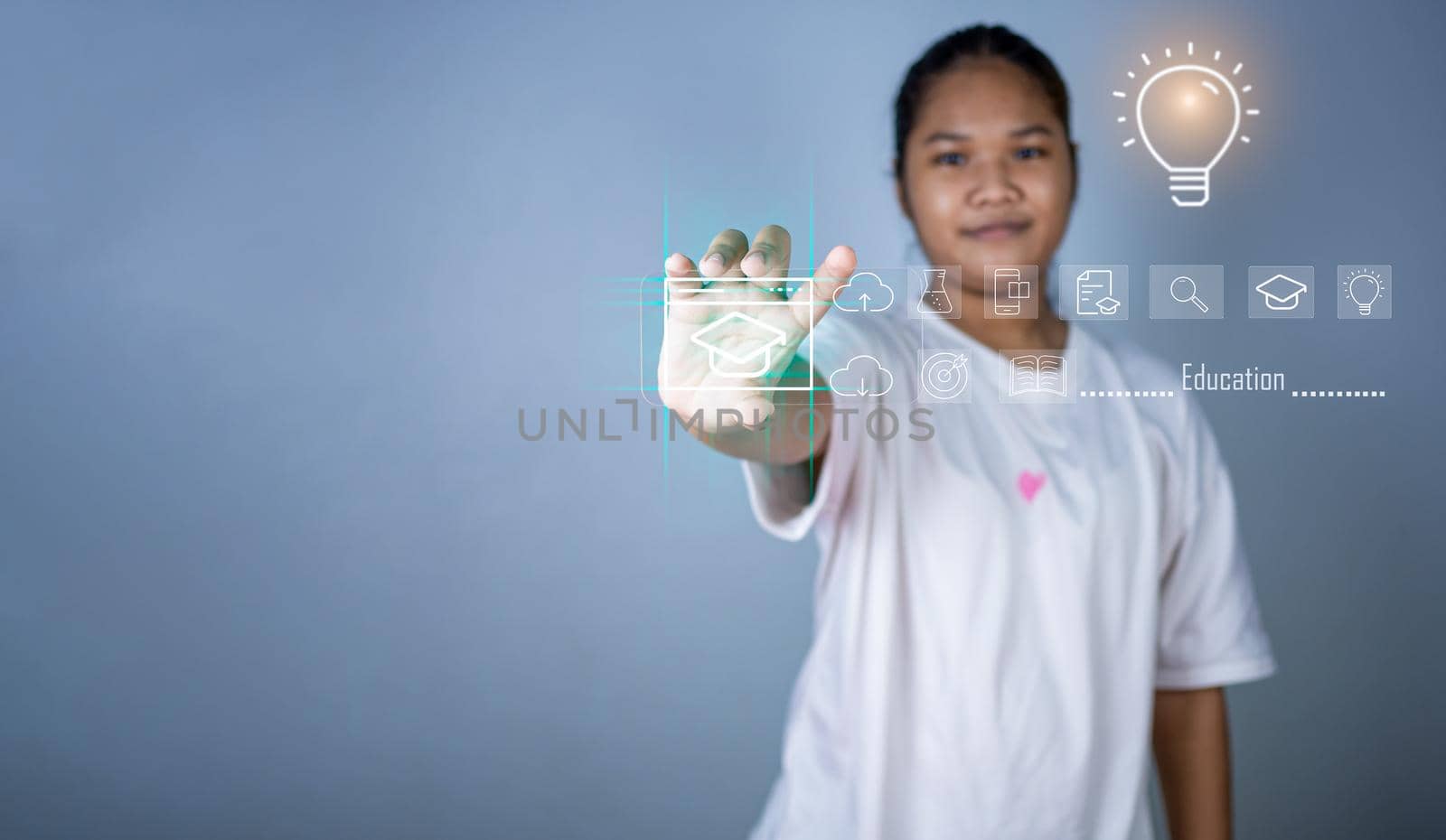 Educational concept picture. A girl stands holding an education icon representing creativity and innovation. Guidelines for searching for educational information. copy space