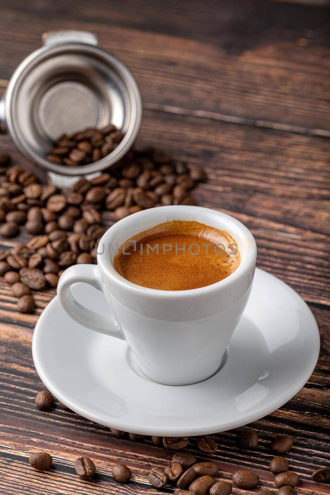 Fresh espresso coffee together decorated with coffee beans on wooden table by Sonat
