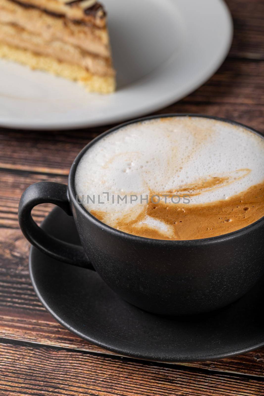 Fresh cappuccino coffee together decorated with coffee beans on wooden table by Sonat