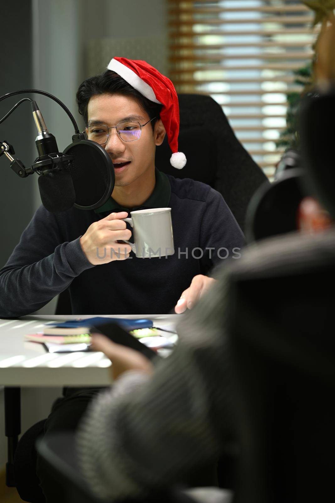 Image of radio host using microphone and laptop to recording podcast in home studio. Radio, podcasts and technology concept by prathanchorruangsak