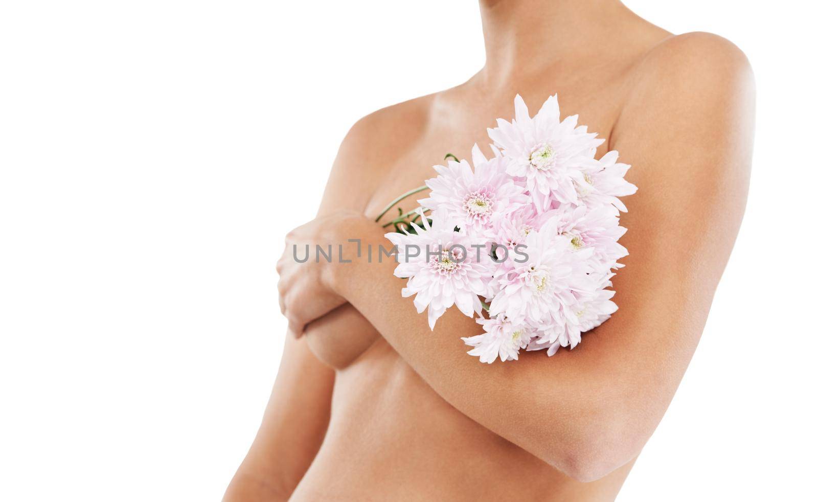 Natural beauty. A bare pregnant woman holding a bouquet of flowers while isolated on a white background