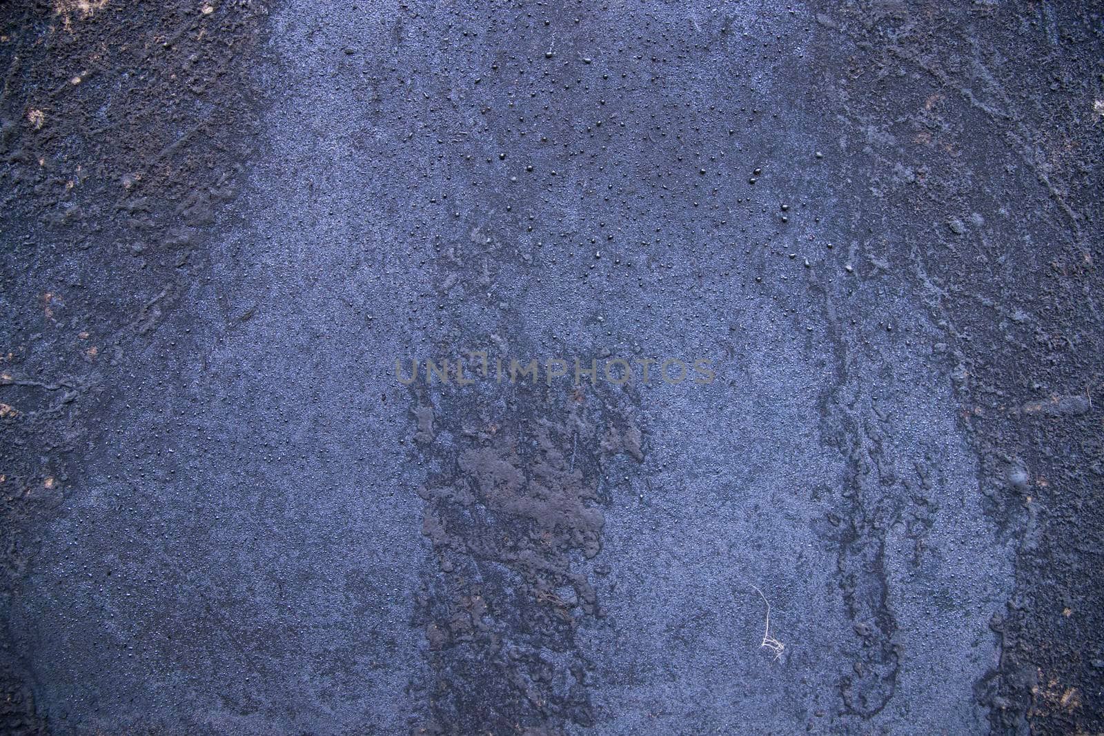 Old metal surface covered black ash  abstract background texture