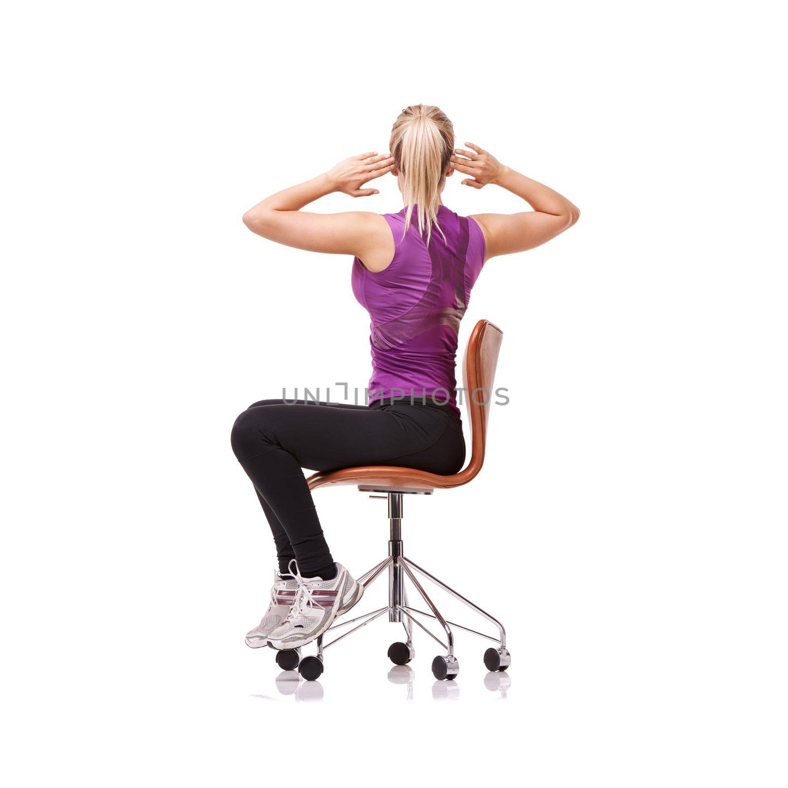 Perfect for your posture. a sporty woman doing stretches on a chair. by YuriArcurs