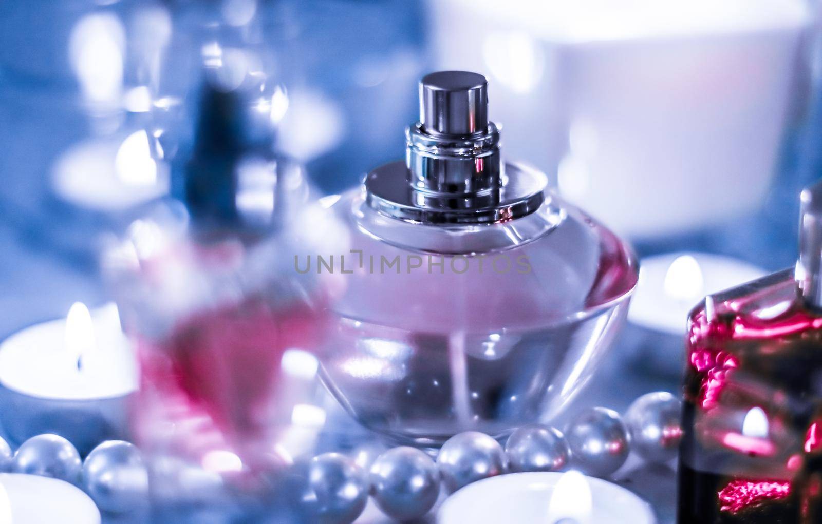 Perfumery, cosmetics branding and luxe concept - Perfume bottle and vintage fragrance on glamour vanity table at night, pearls jewellery and eau de parfum as holiday gift, luxury beauty brand present