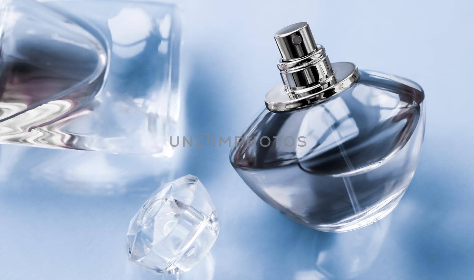 Perfumery, spa and branding concept - Blue perfume bottle on glossy background, sweet floral scent, glamour fragrance and eau de parfum as holiday gift and luxury beauty cosmetics brand design