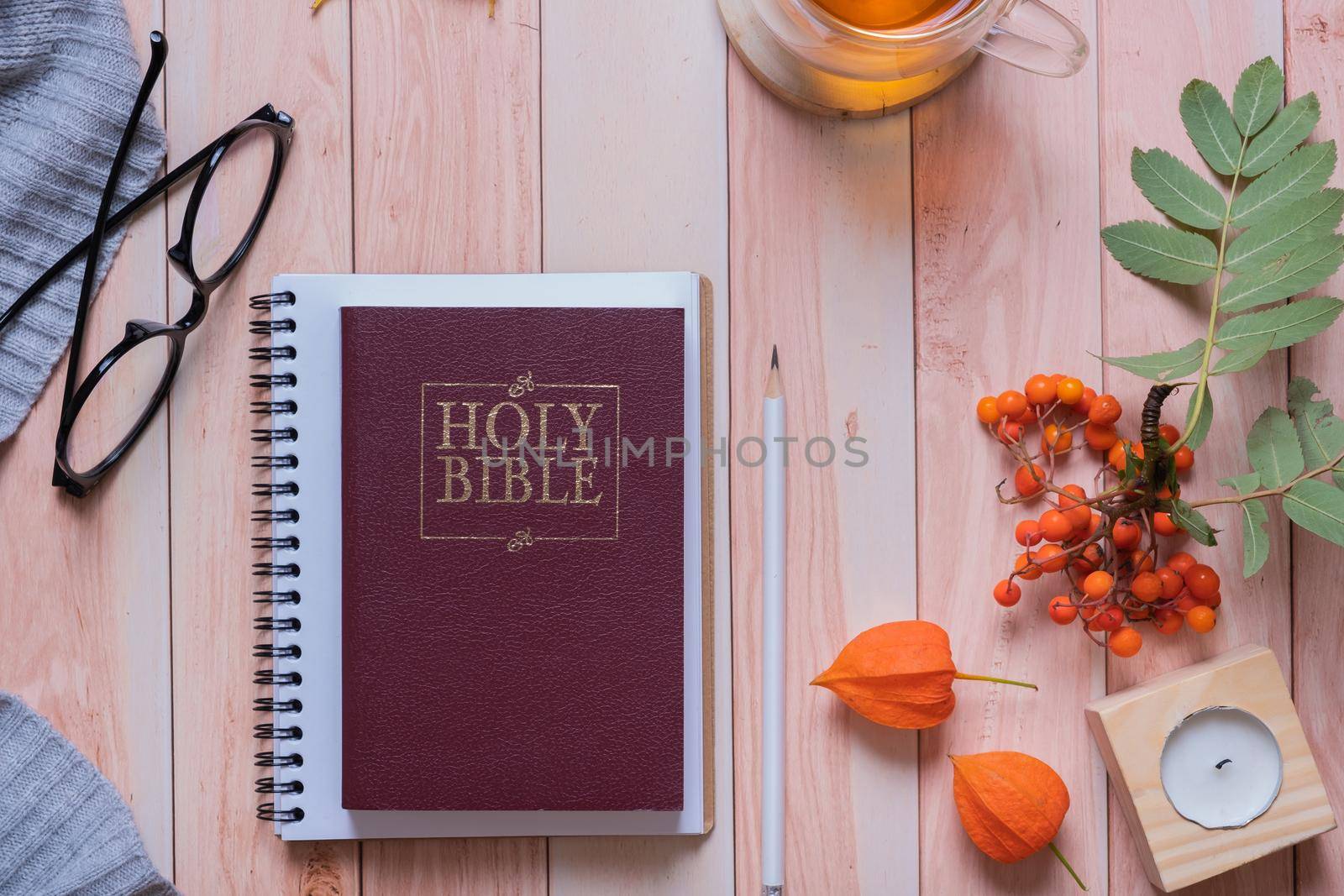 Holy bible and autumn cozy top view on wooden background. Bible study autumn concept by ssvimaliss
