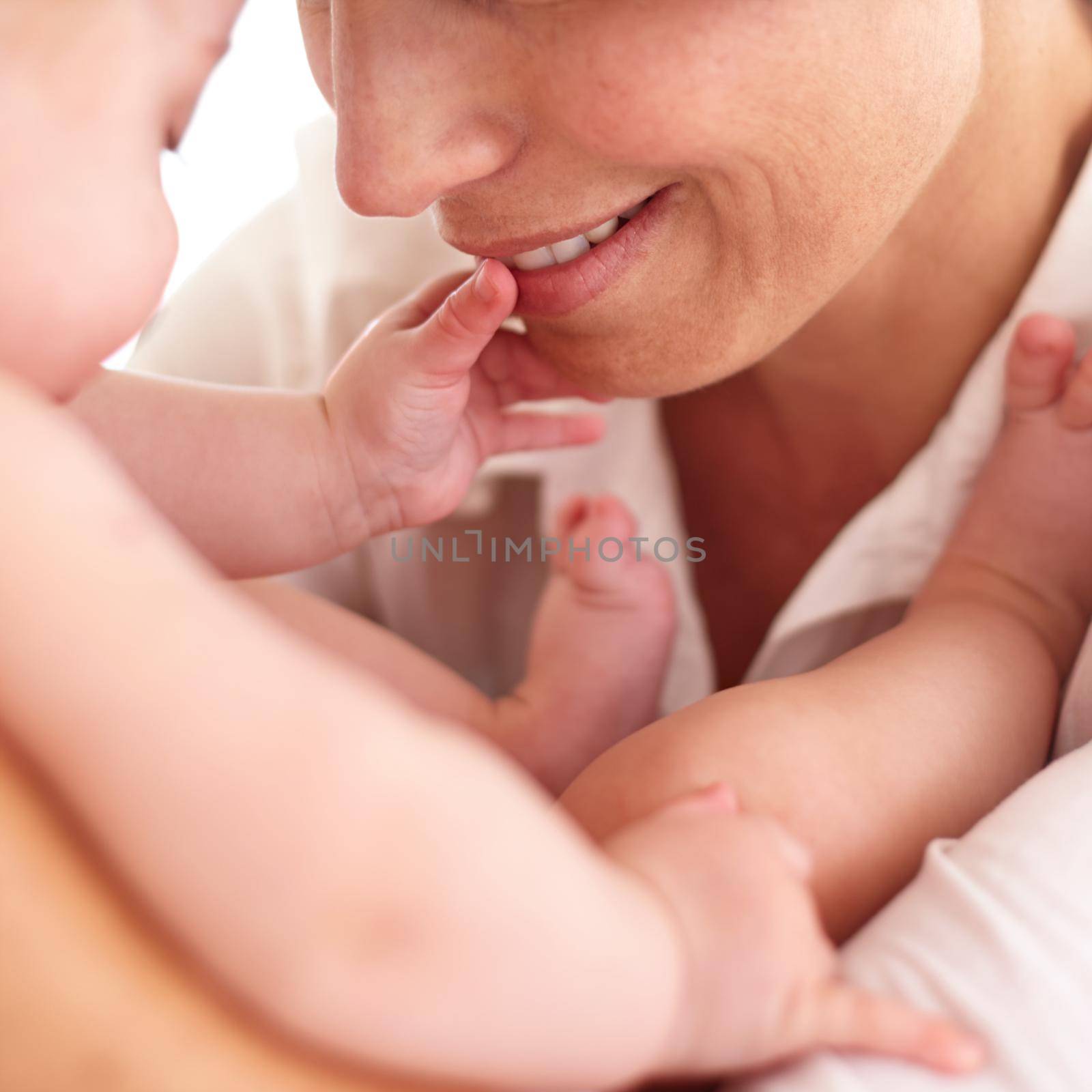 Touching the face of motherly love. Cropped image of a baby touching its mothers face. by YuriArcurs