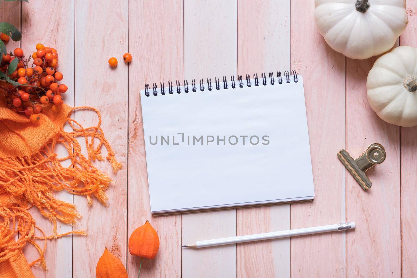 Blank sheet of note pad paper and autumn cozy decor top view. Copy space for autumn text by ssvimaliss