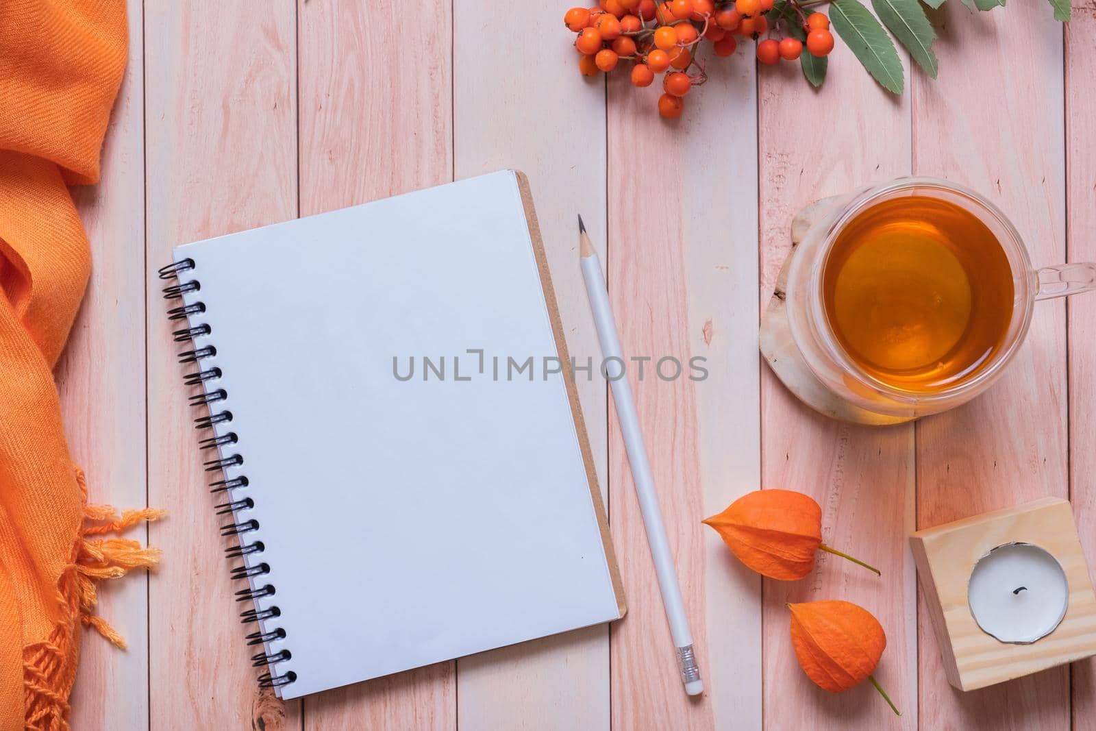 Blank sheet of paper note pad and autumn cozy decor top view. Copy space for autumn text.