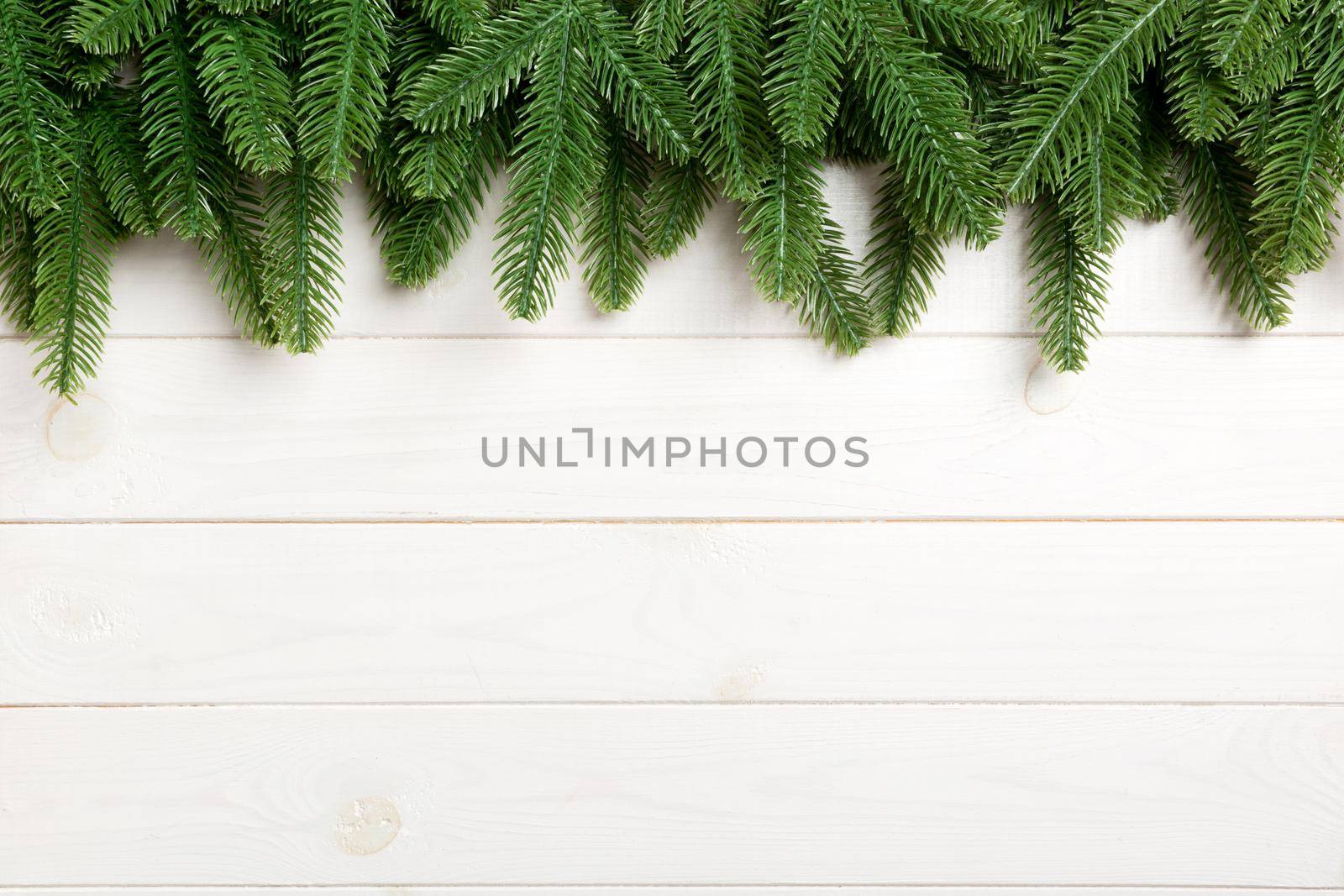 Top view of fir tree on wooden background. Christmas concept with copy space.