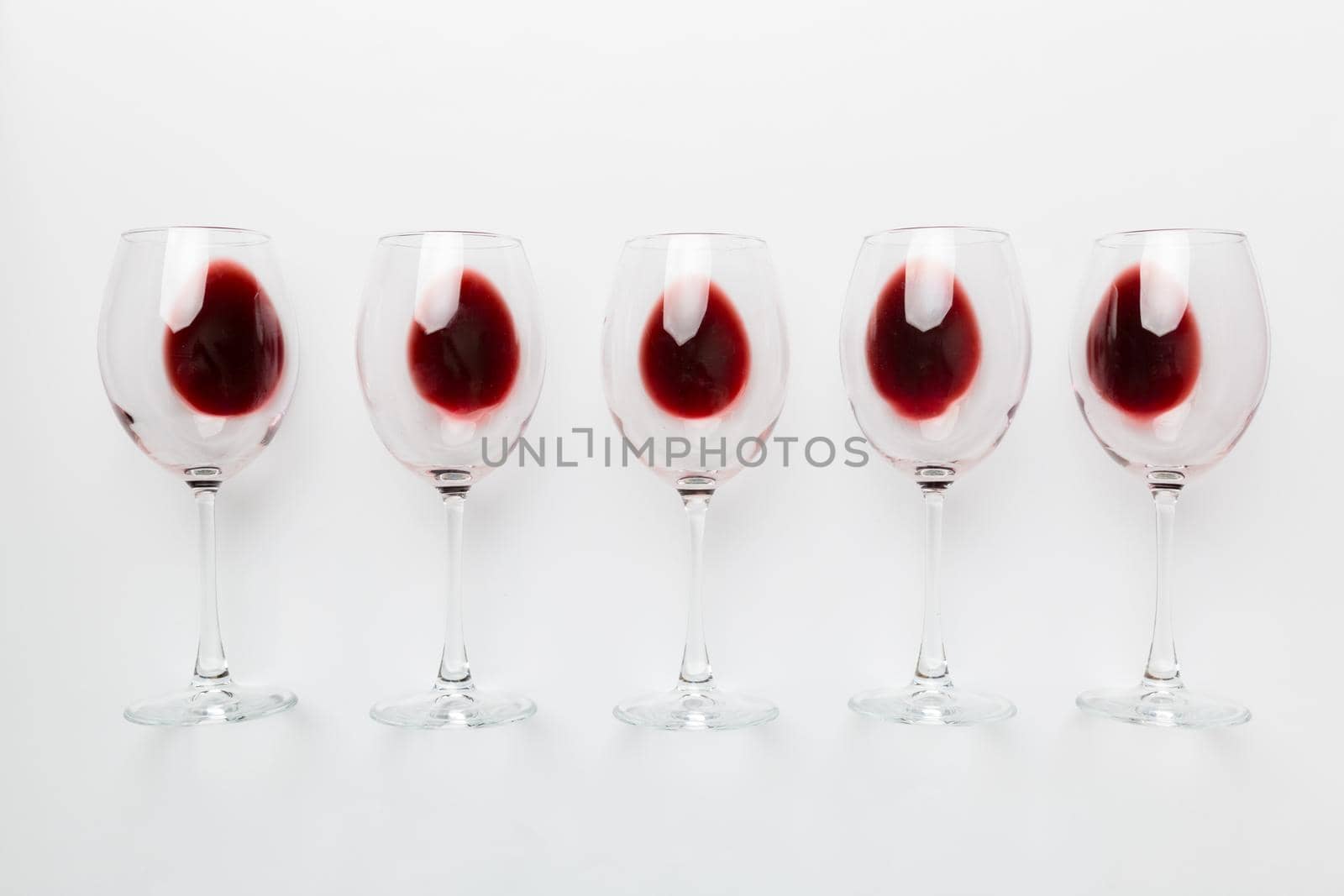 Many glasses of red wine at wine tasting. Concept of red wine on colored background. Top view, flat lay design.