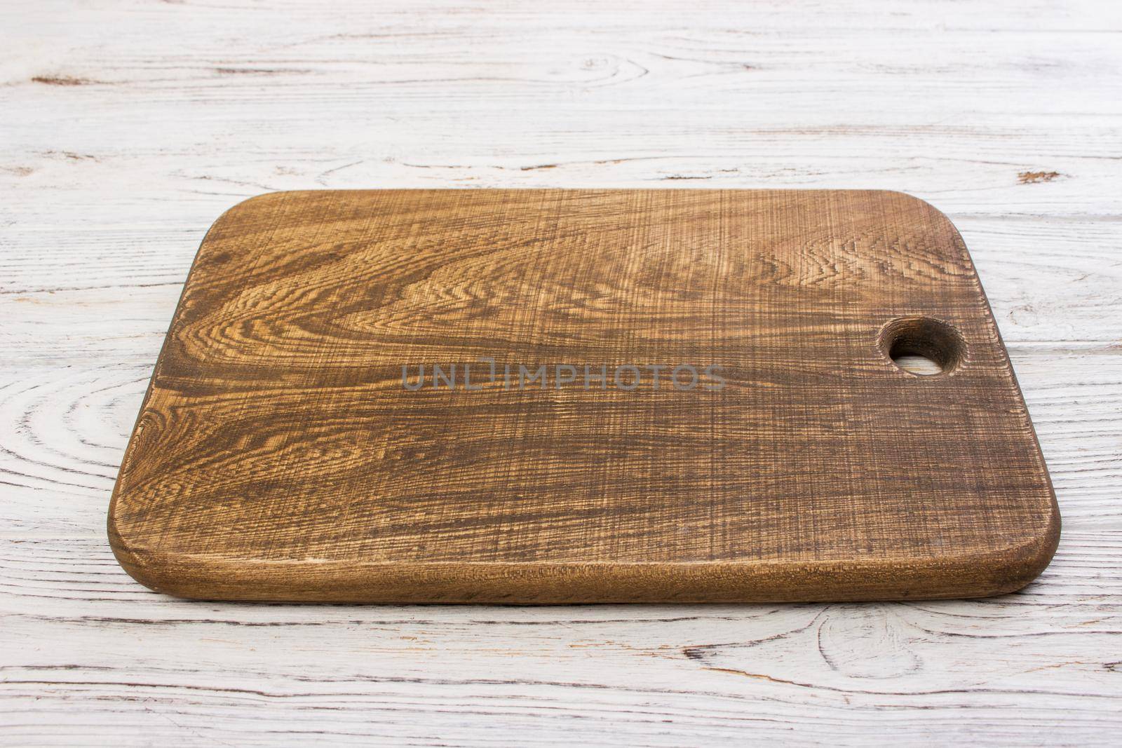 Wooden chop board on rustic wooden table top. Top view.