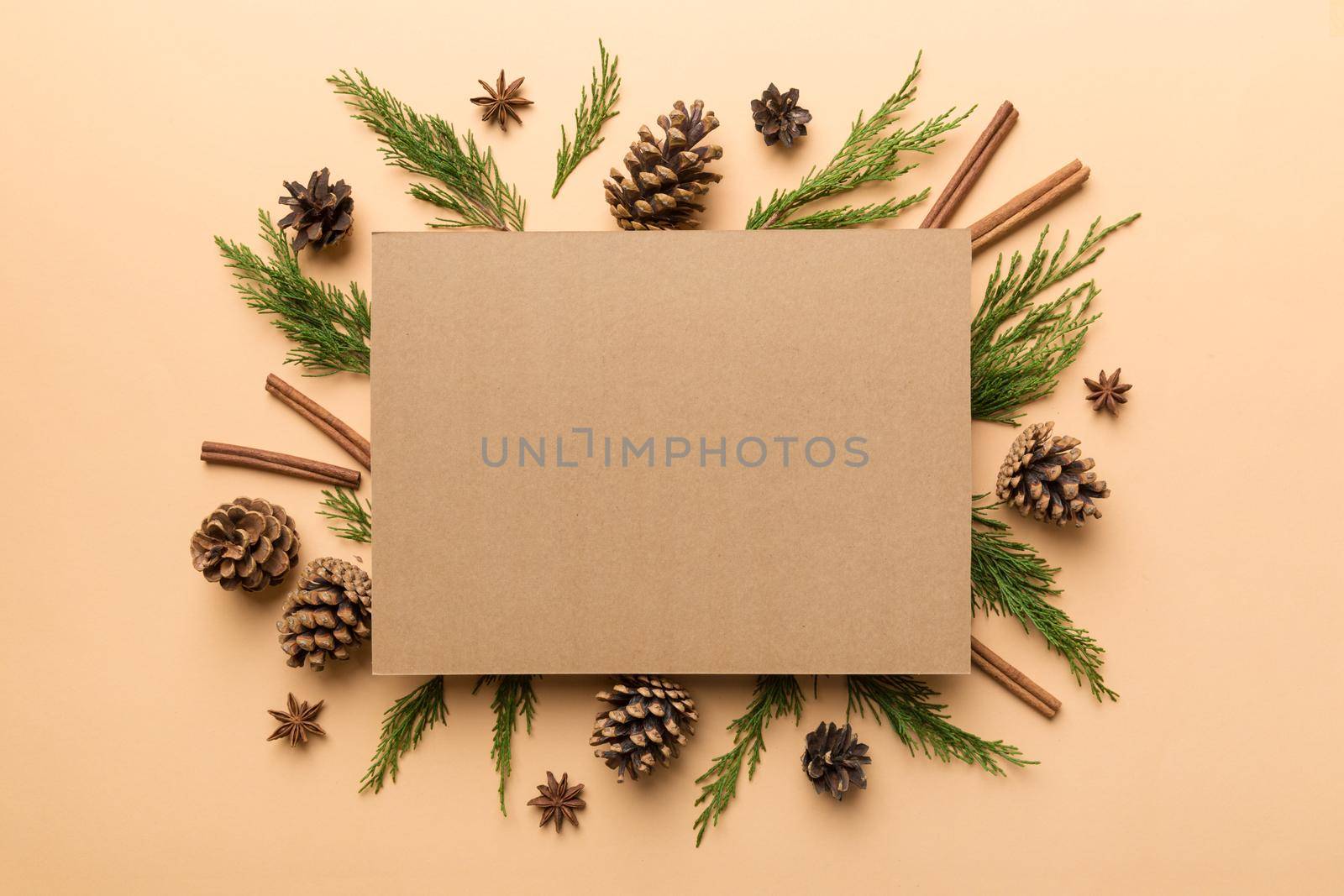 Flat lay Christmas composition. square Paper blank, pine tree branches, christmas decorations on Colored background. Top view, copy space for text by Snegok1967