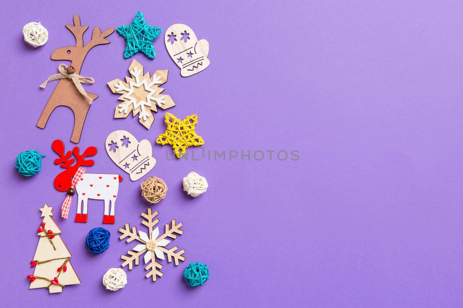 Festive decorations and toys on purple background. Merry Christmas concept with copy space.