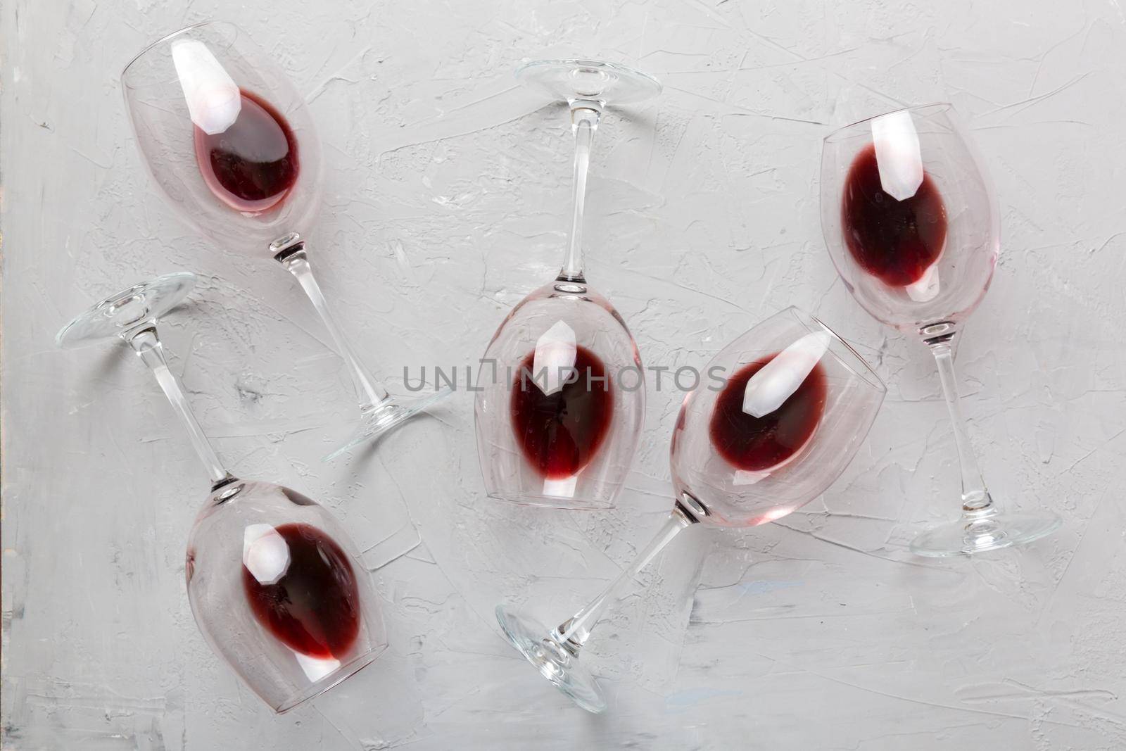 Many glasses of red wine at wine tasting. Concept of red wine on colored background. Top view, flat lay design.