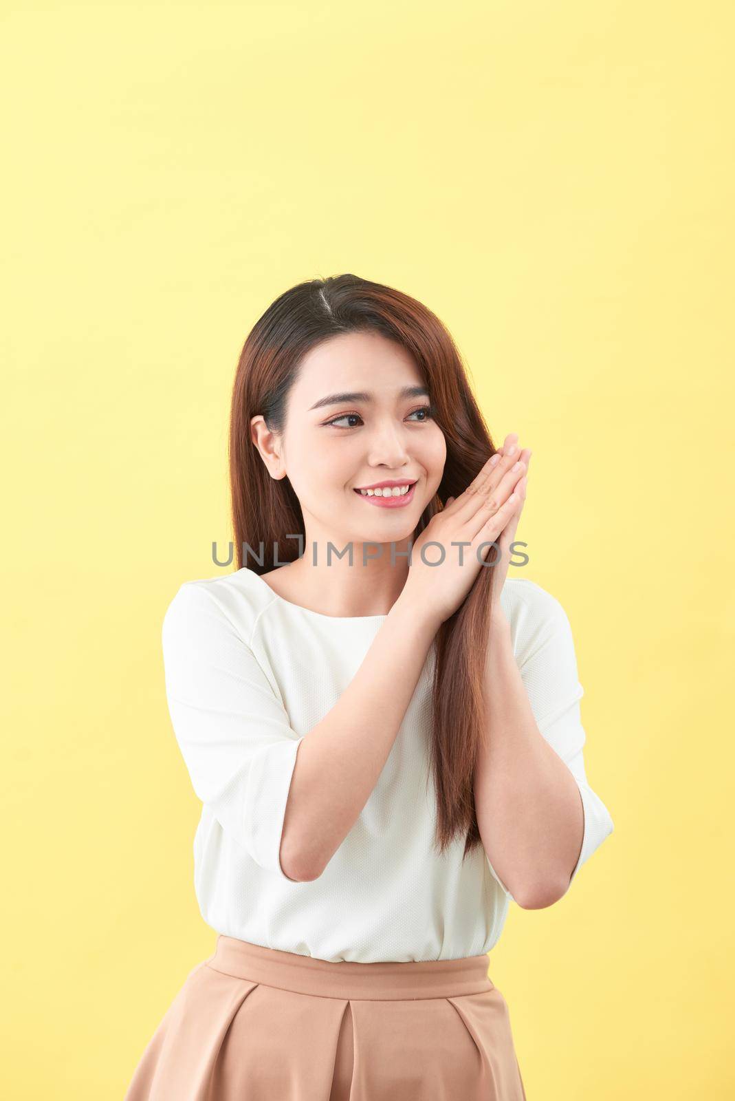 Beauty woman touch her long hair isolated on yellow background, asian beauty  by makidotvn