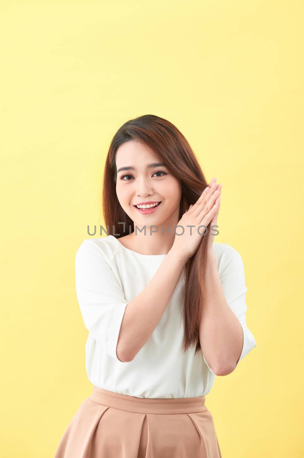 Beauty woman touch her long hair isolated on yellow background, asian beauty  by makidotvn