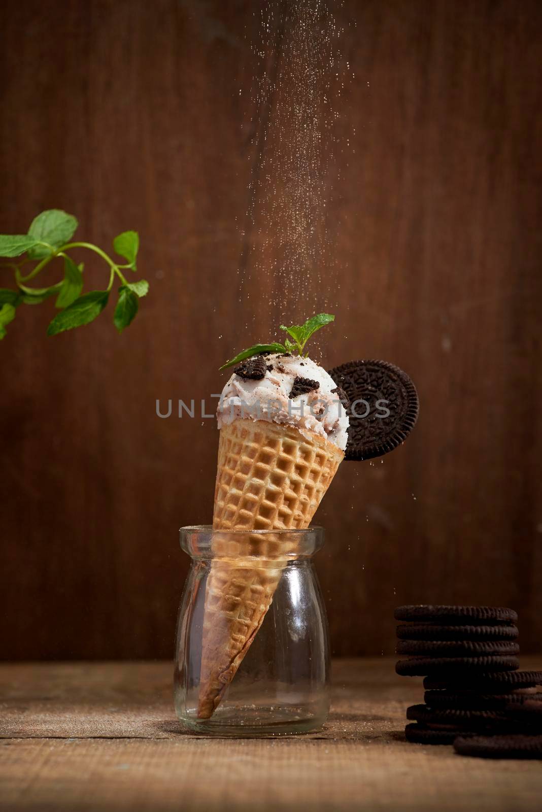 Sweet homemade ice cream with cookies in cone, selective focus by makidotvn