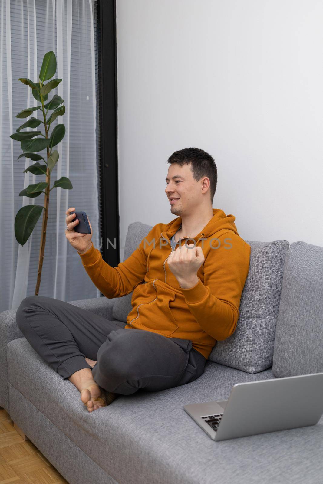 young man watching at mobile phone playing game. High quality photo