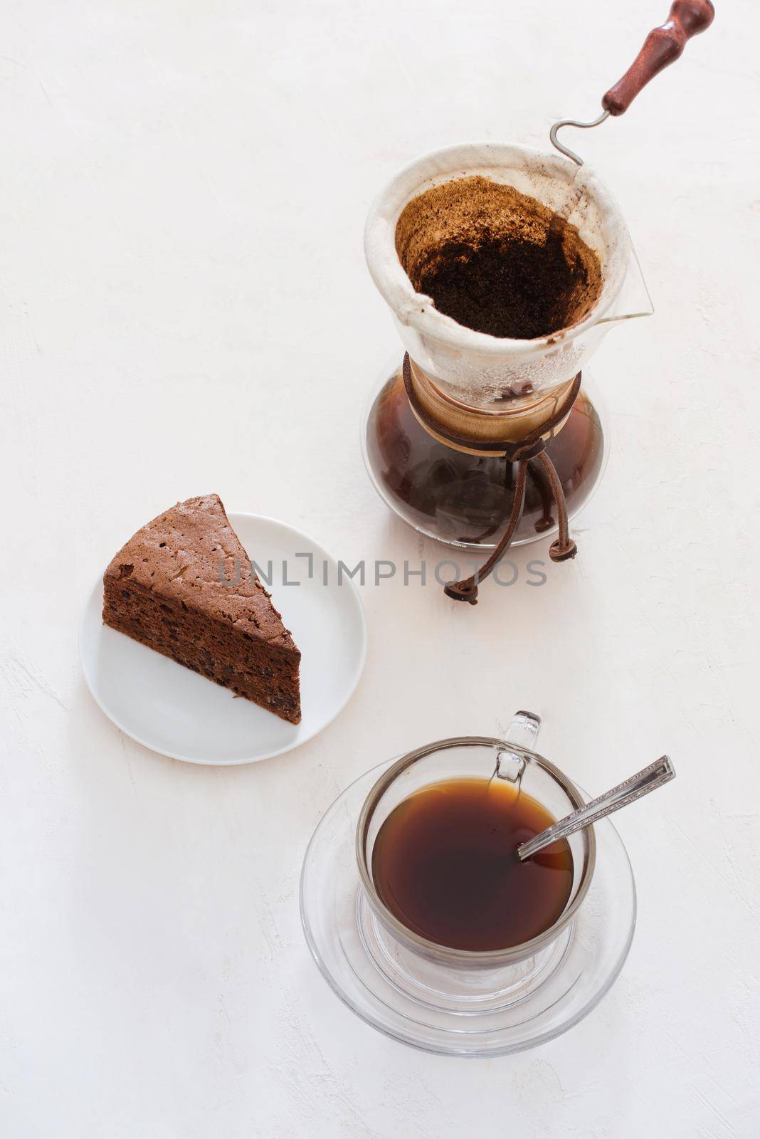 Drip coffee (dripper) and drip ground coffee with glass drip pot, cup and chocolate cake