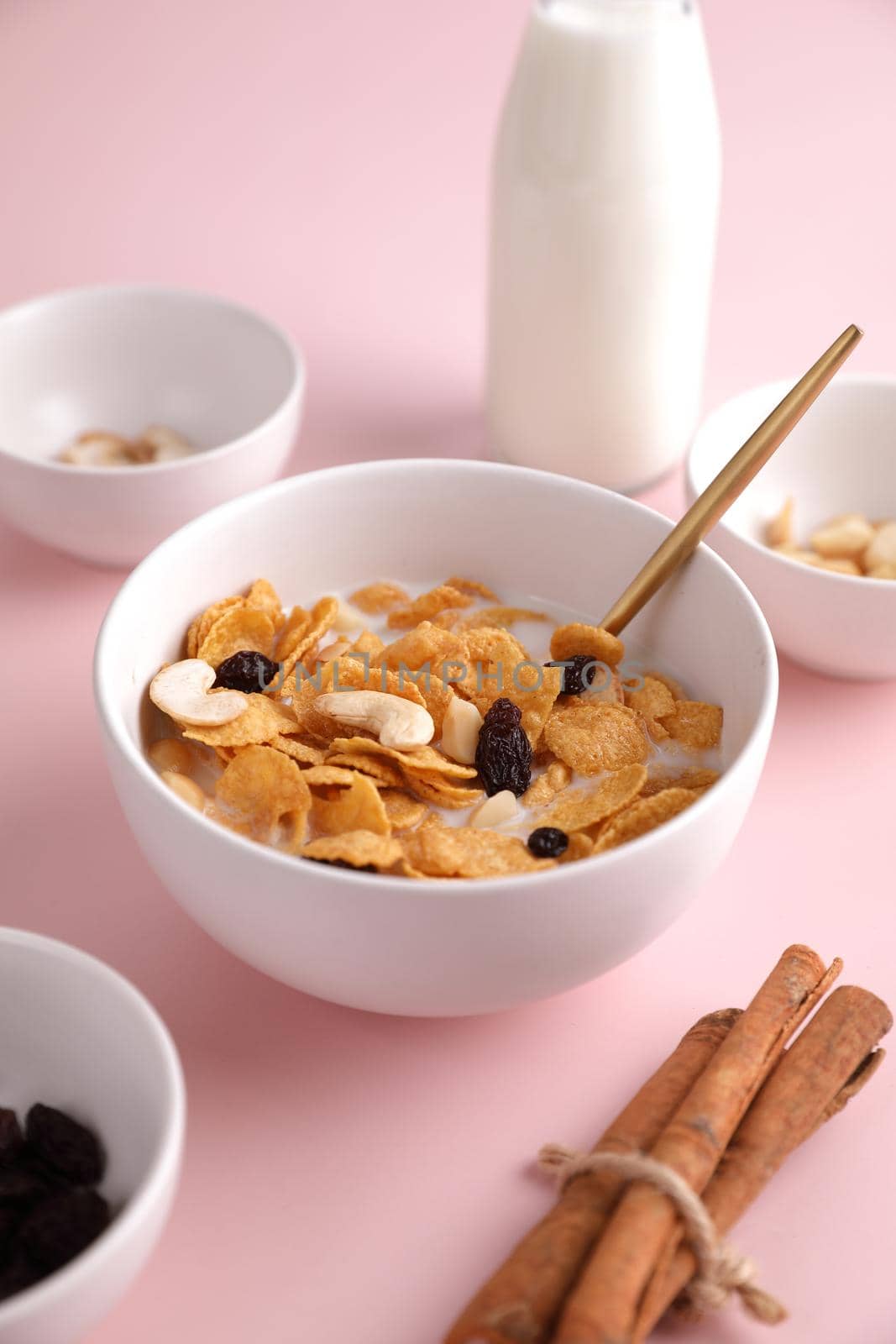 Cereal dessert with corn oat and dry fruits isolated in pink background