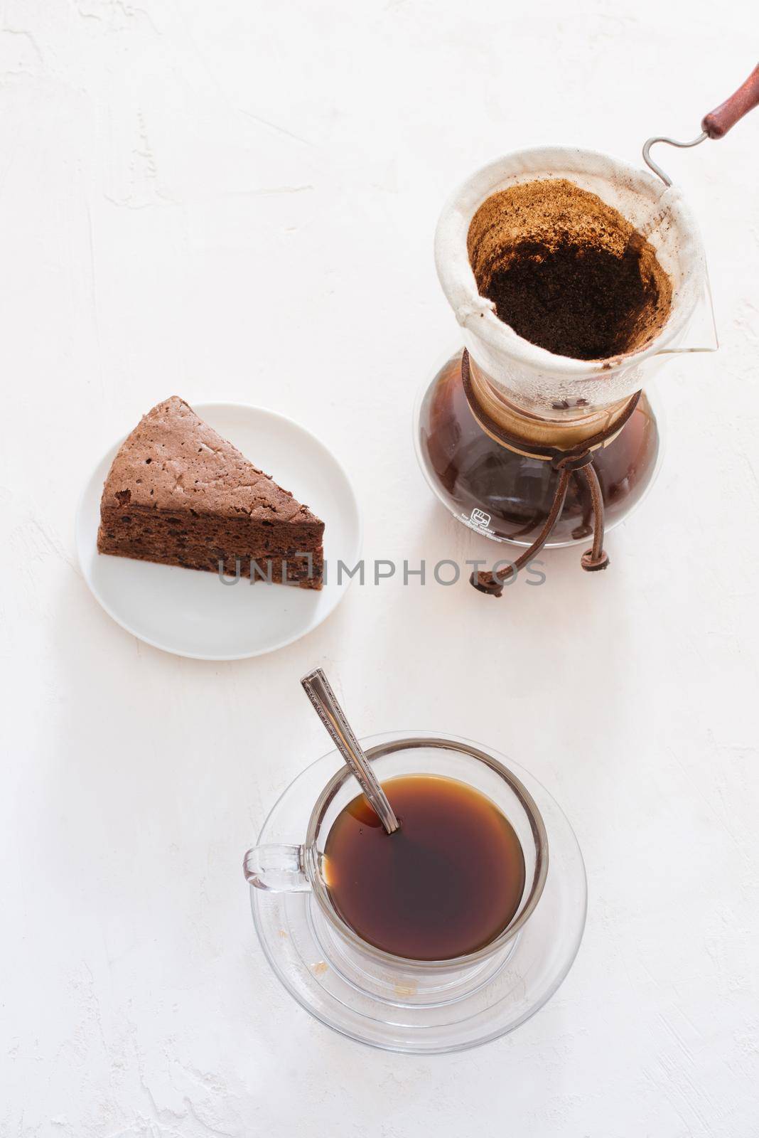 Drip coffee (dripper) and drip ground coffee with glass drip pot, cup and chocolate cake