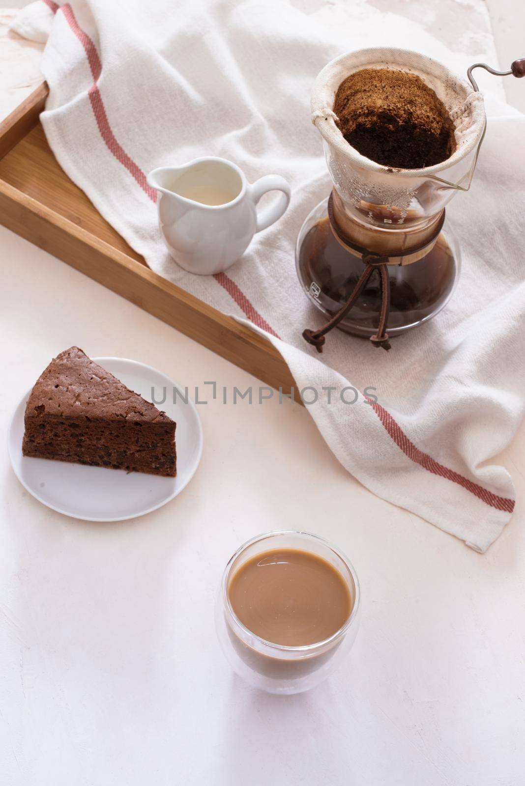 Drip coffee (dripper) and drip ground coffee with glass drip pot, cup and chocolate cake