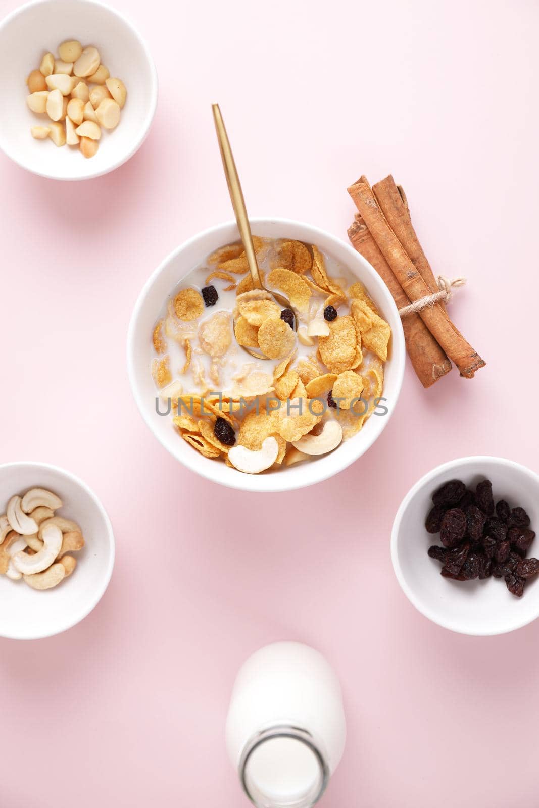 Cereal dessert with corn oat and dry fruits isolated in pink background by piyato