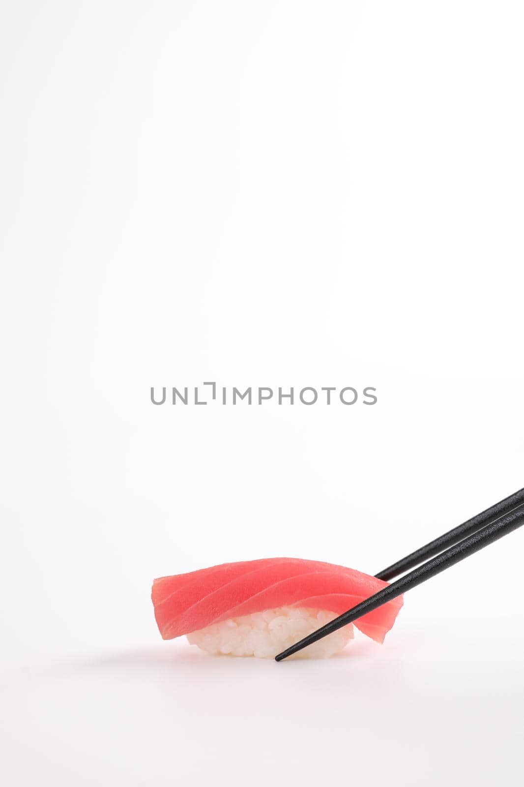 Tuna sushi with chopsticks , Japanese food isolated in white background by piyato