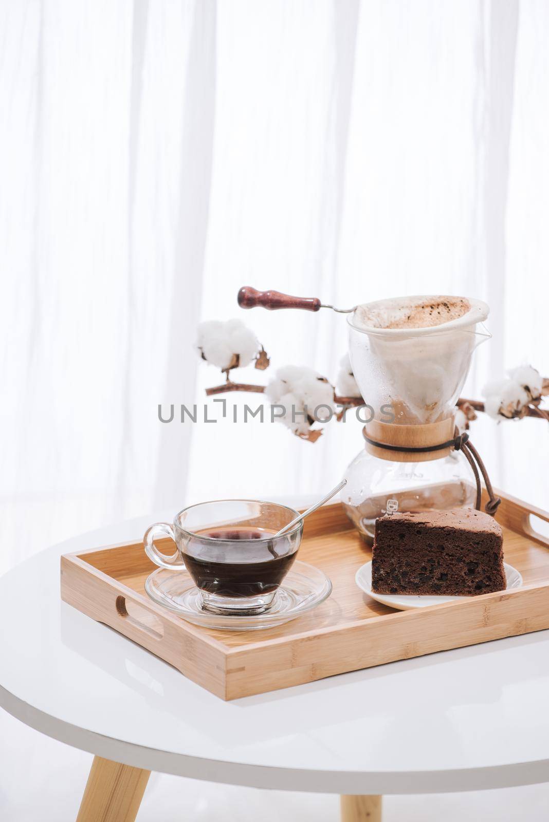 Drip coffee (dripper) and drip ground coffee with glass drip pot, cup and chocolate cake