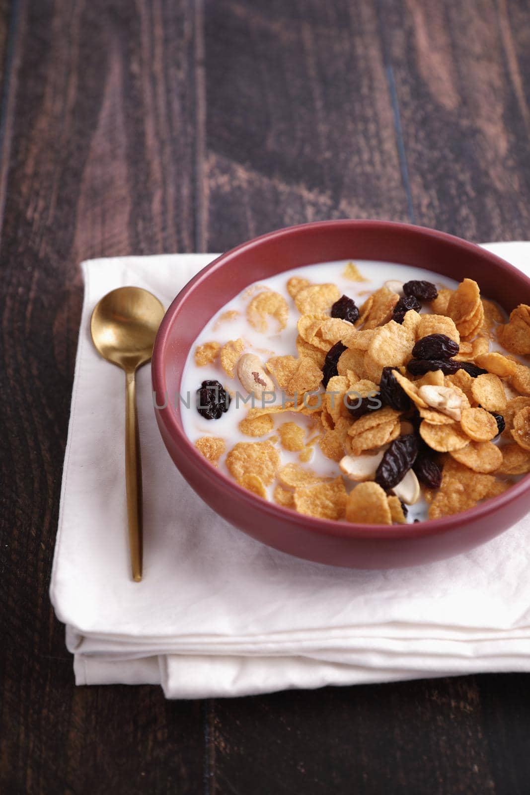 Cereal dessert with corn oat and dry fruits isolated in wood background