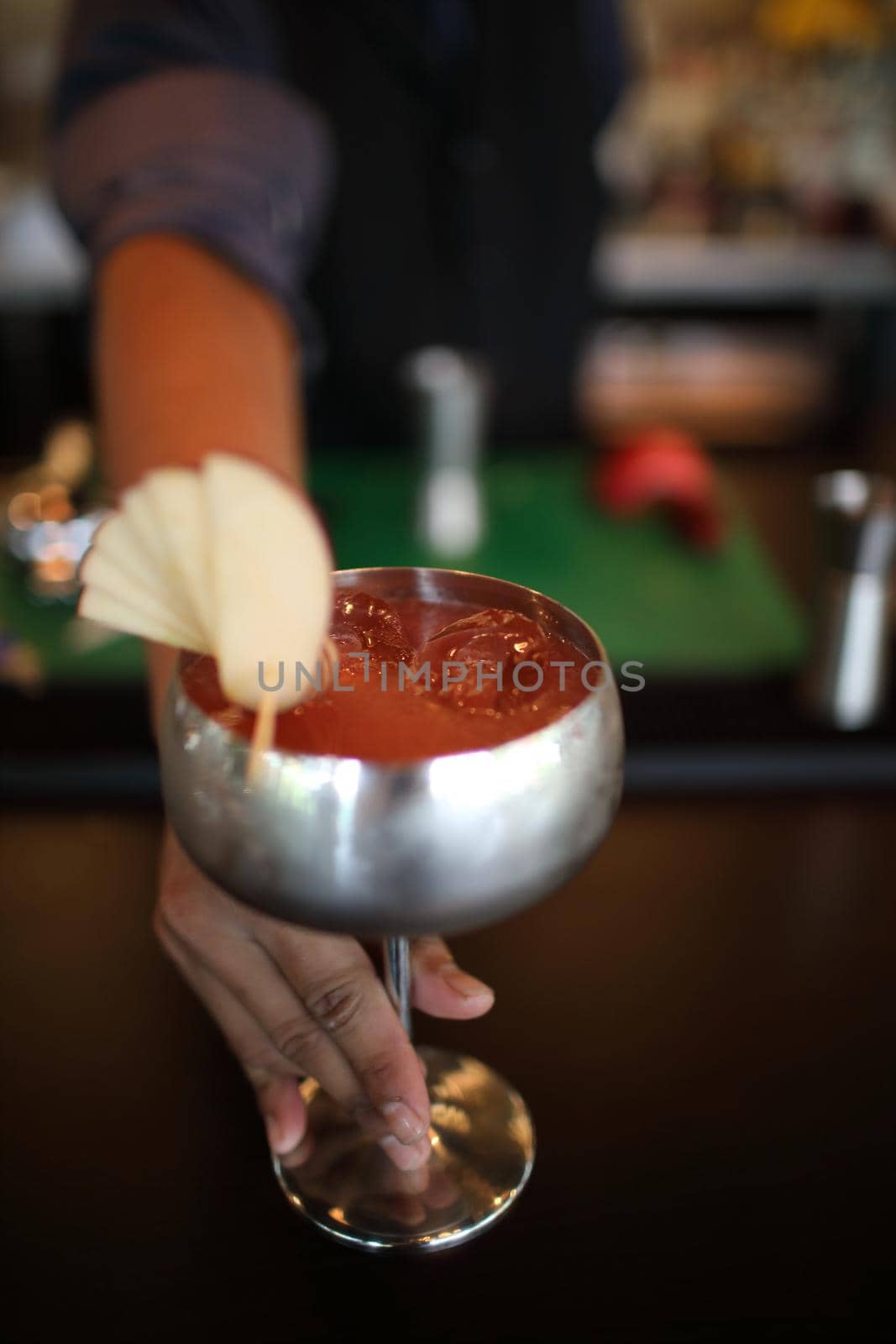 cocktails in glasses on bar counter in pup or restaurant