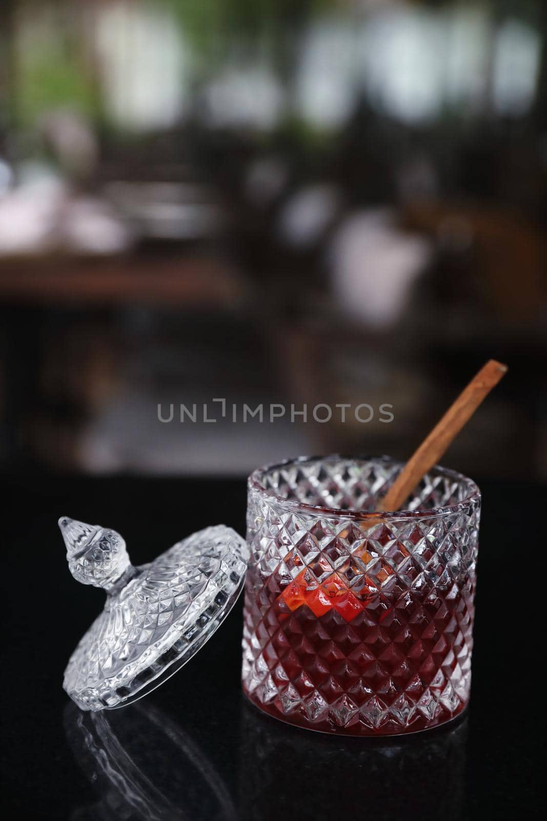 Pink Cocktail glass with ice at a bar counter