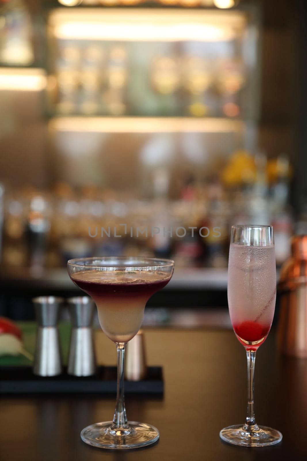 cocktails in glasses on bar counter in pup or restaurant