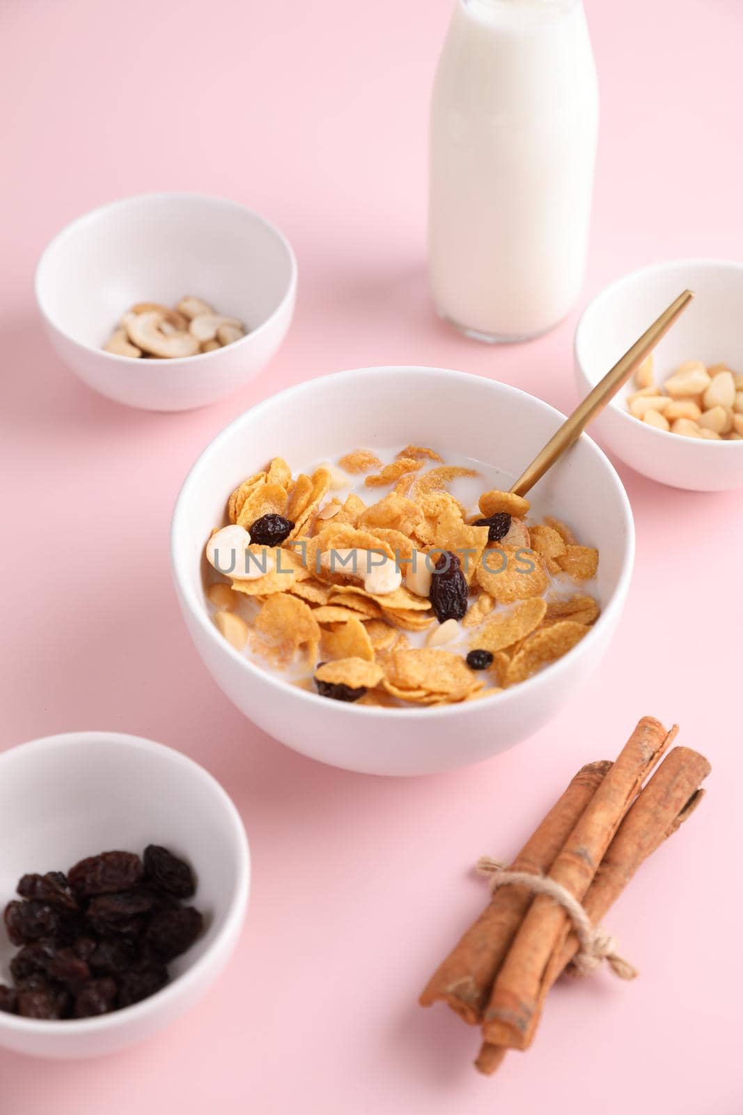 Cereal dessert with corn oat and dry fruits isolated in pink background by piyato