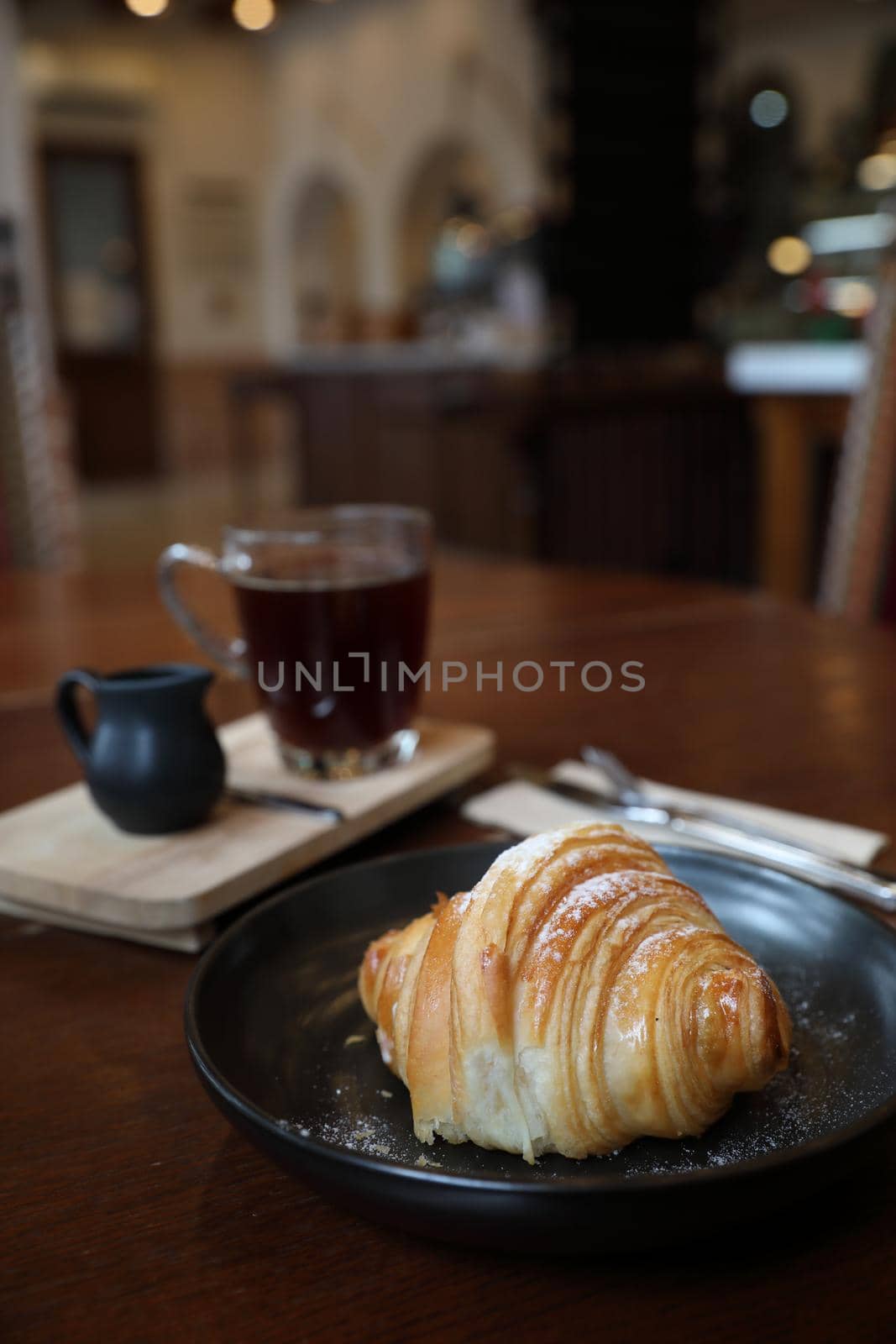 croissant with coffee close up on wood background