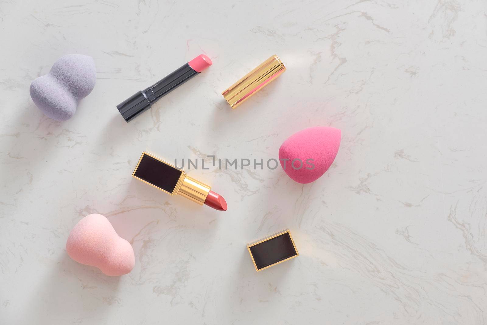 Feminine cosmetic background. Overhead of essentials of a modern woman. Cosmetic objects frame by makidotvn