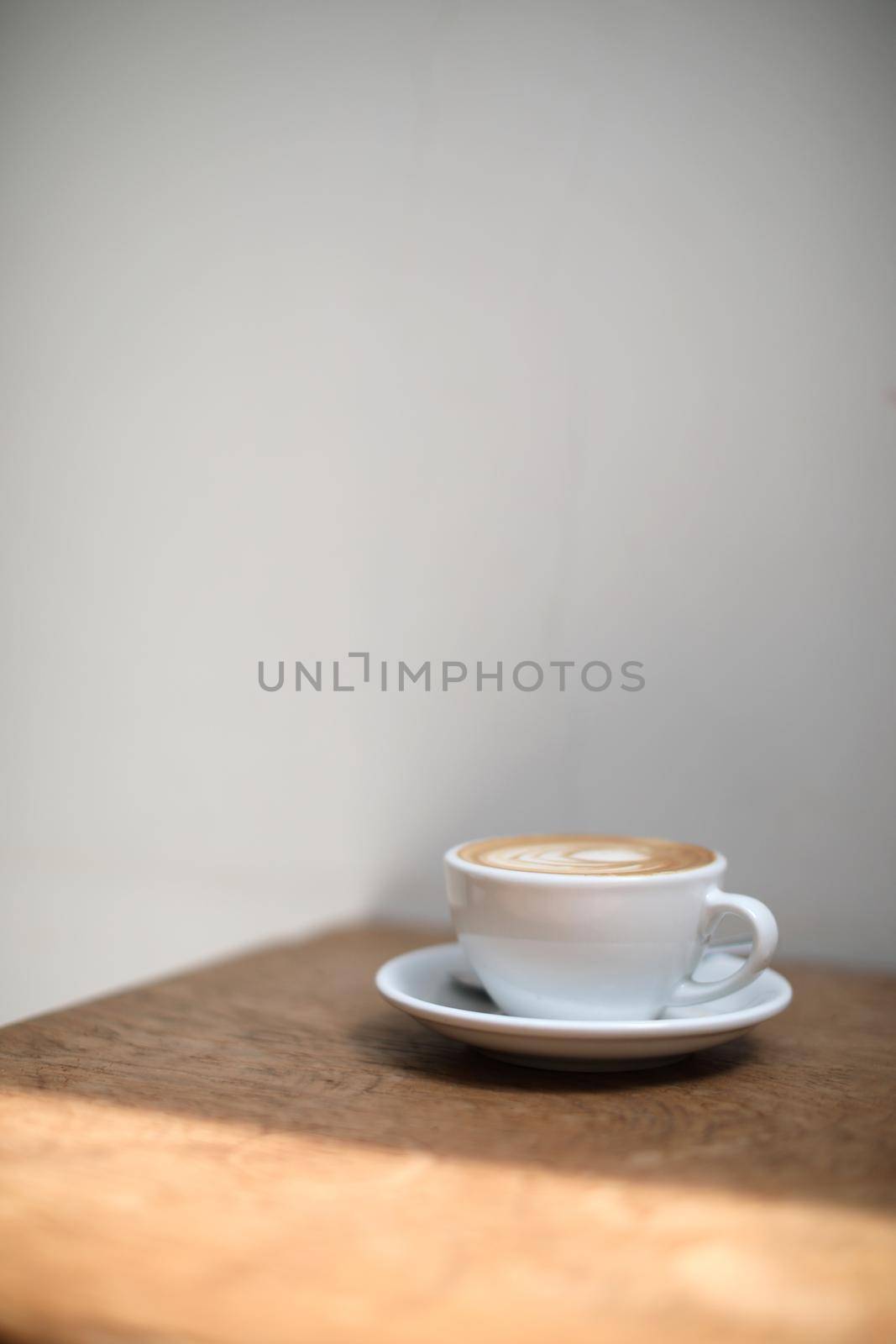 cappuccino or Latte art coffee made from milk on the wood table in coffee shop by piyato