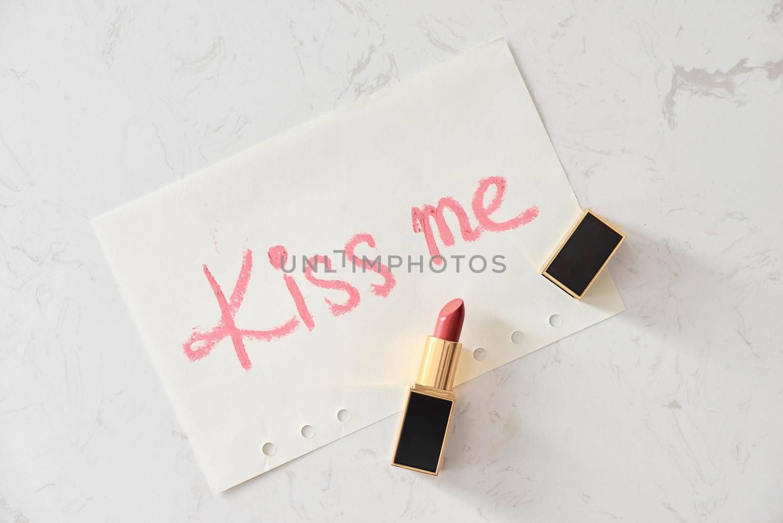 a kiss on a white background lipstick. selective focus. by makidotvn