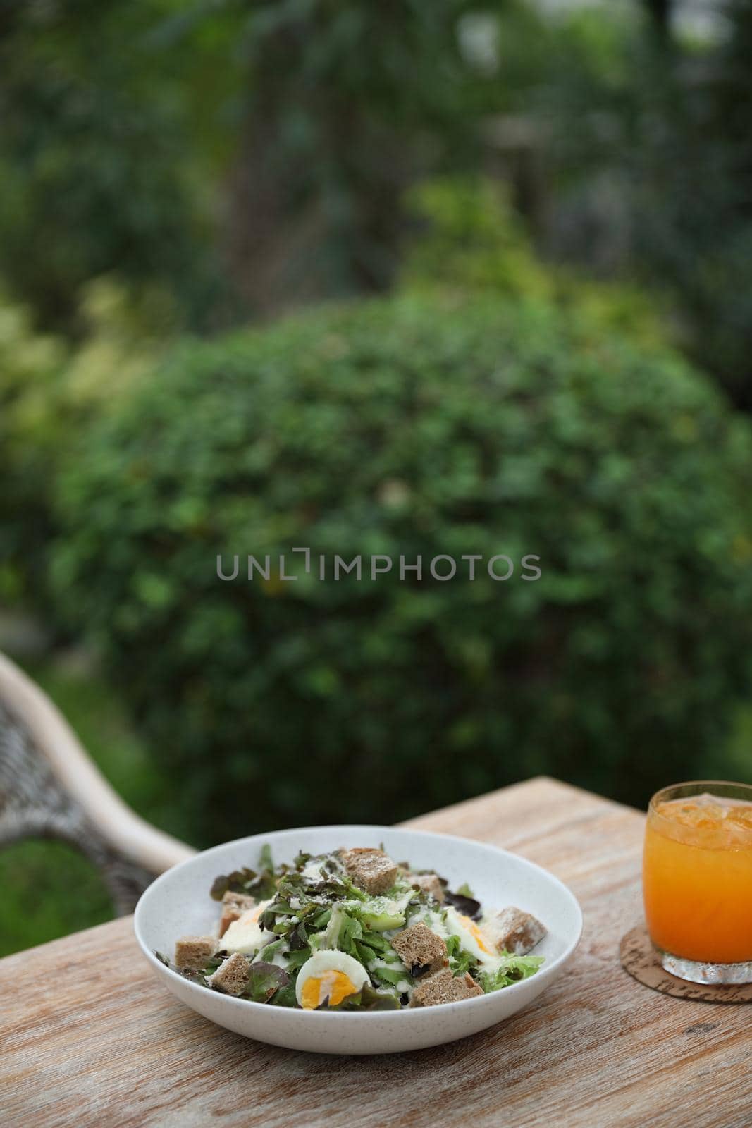 caesar salad appetizer on wooden background by piyato