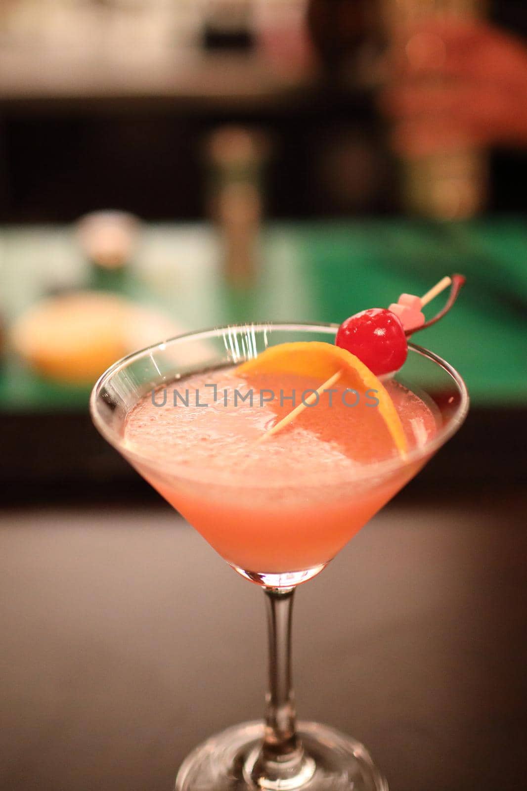 cocktails in glasses on bar counter in pup or restaurant