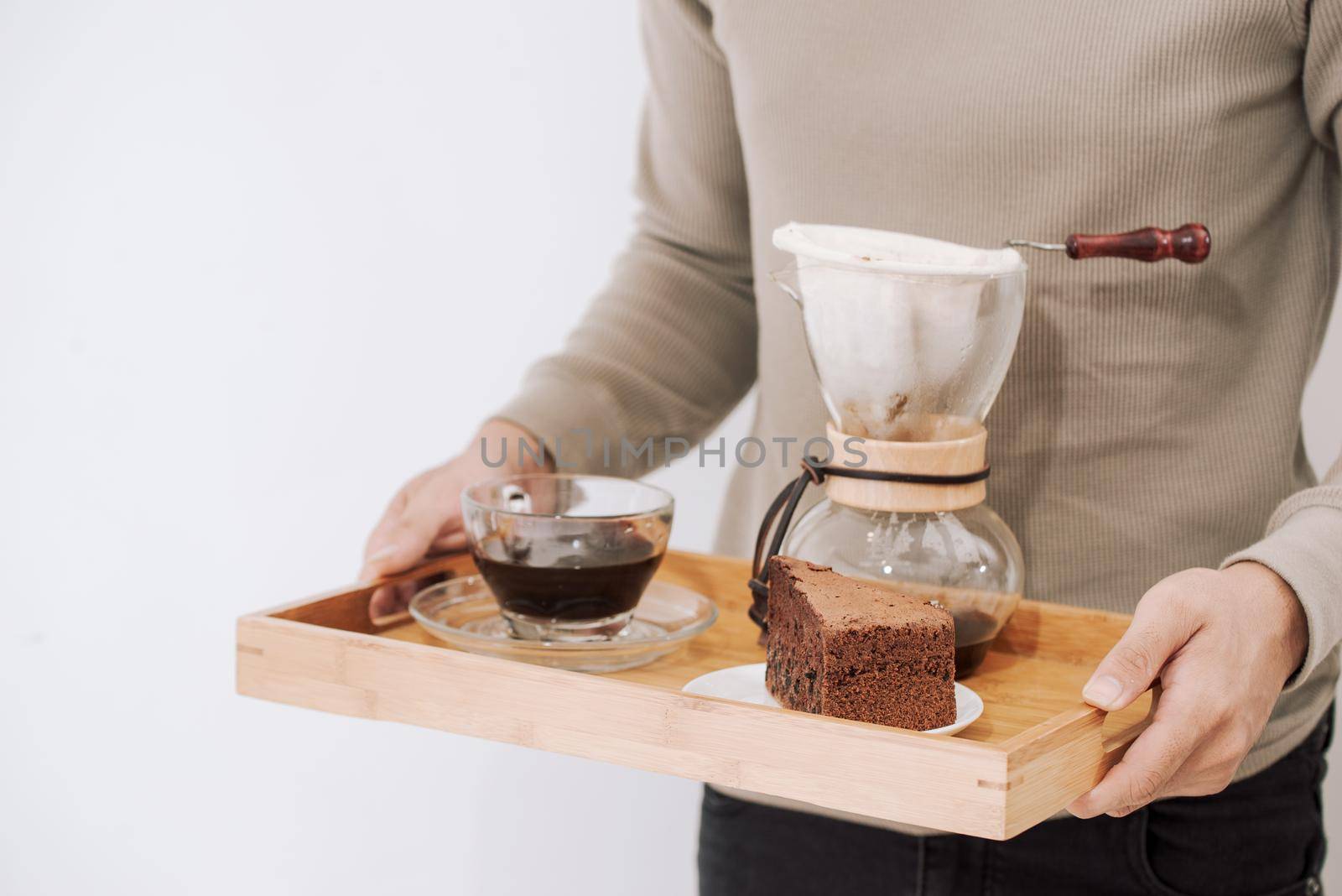 Drip coffee on wooden tray with chocolate cake. Coffee time on the cafe with natural light by makidotvn