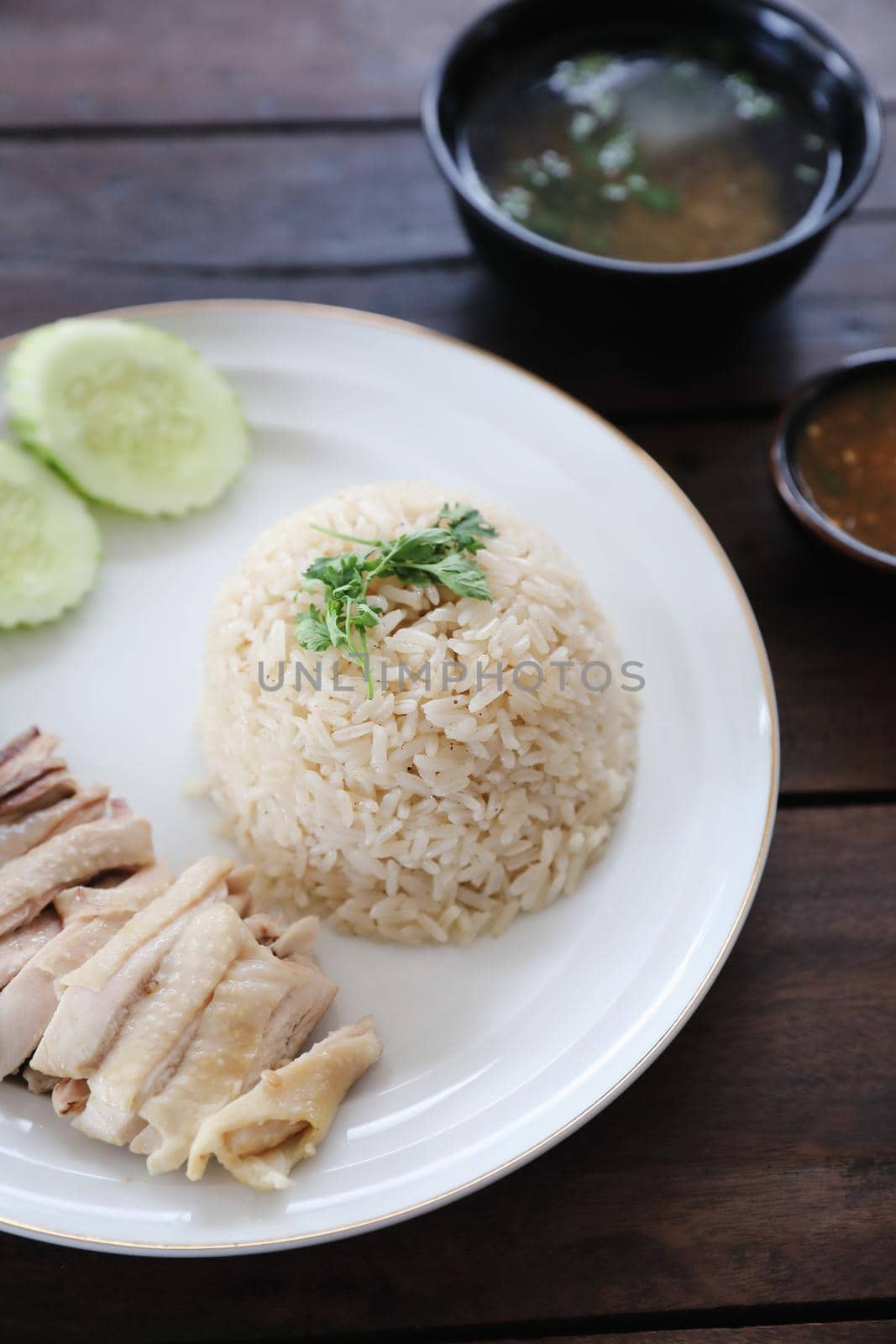 Thai food gourmet steamed chicken with rice khao mun kai in wood background 