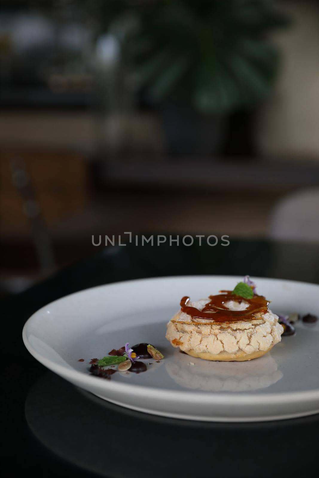 Chocolate dessert cake with berry sauce and almond with decorated by piyato