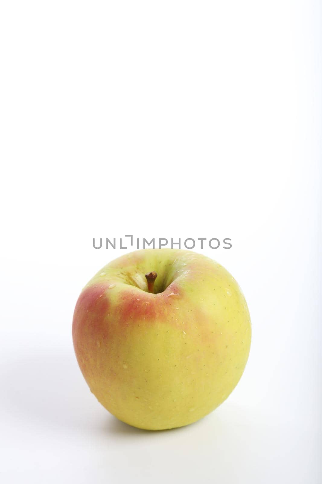 Red yellow apple isolated in white background by piyato